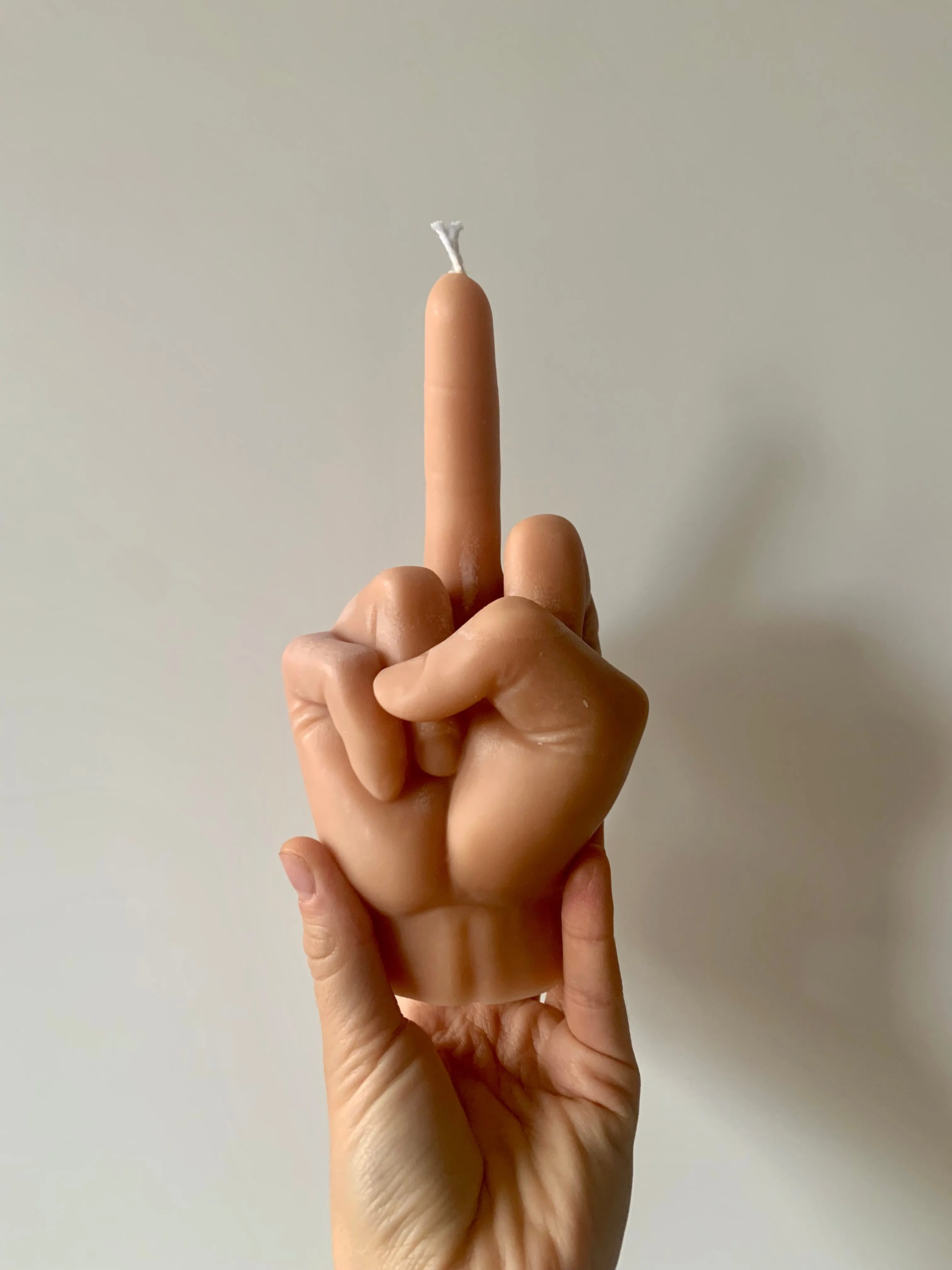 Middle Finger Candle  FLIP OFF sign wax art, protest, defiance, expression, humor, statement, controversy, bold, irreverent, dissent, unconventional art